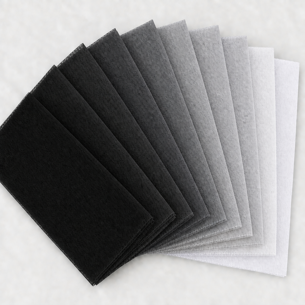Nine black, grey, silver, and white tulle swatches in a square fan layout, with a light background and no words