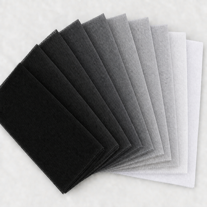 Nine black, grey, silver, and white tulle swatches in a square fan layout, with a light background and no words