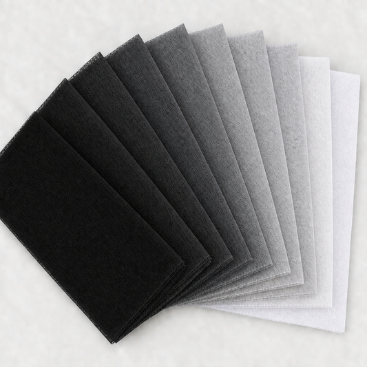 Nine black, grey, silver, and white tulle swatches in a square fan layout, with a light background and no words