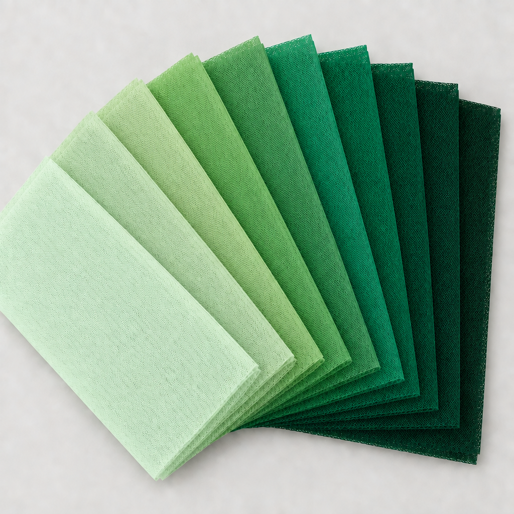 Nine green tulle swatches in a square fan layout, with a light background and no words