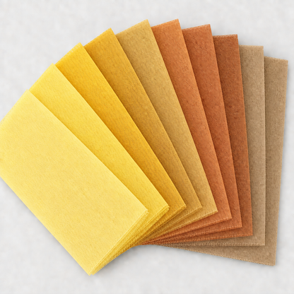Nine yellow, gold, copper, and beige tulle swatches in a square fan layout, with a light background and no words