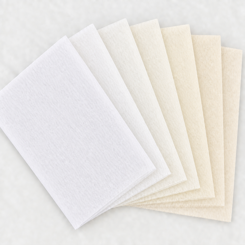 Six white and ivory tulle swatches in a square fan layout, with a light background and no words